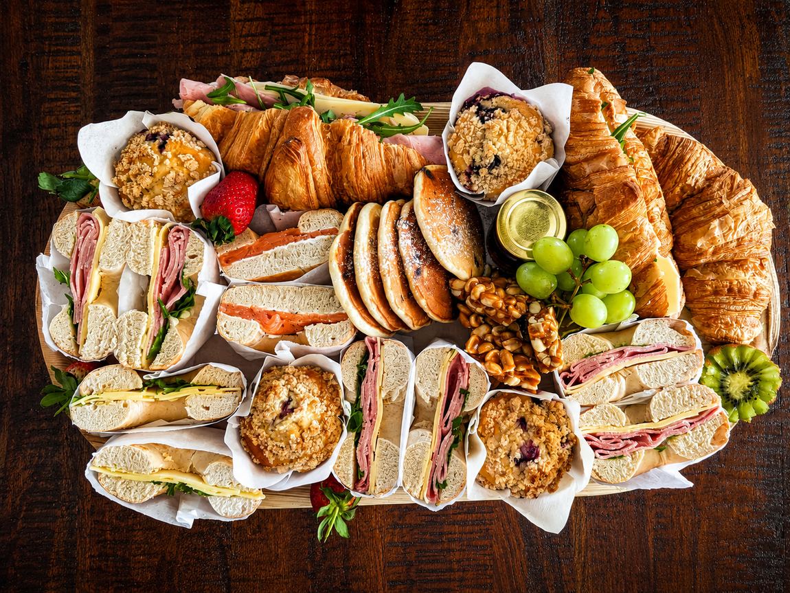 Brunch platter with bagels, croissants, pancake stacks and blueberry muffins