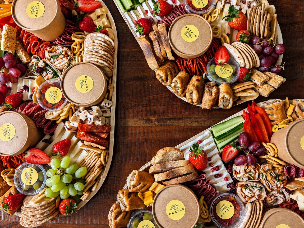 Three graze boards on a wooden table