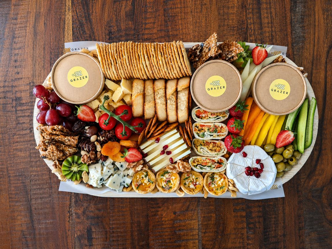 Vegetarian graze board with cheeses, olives and hummus